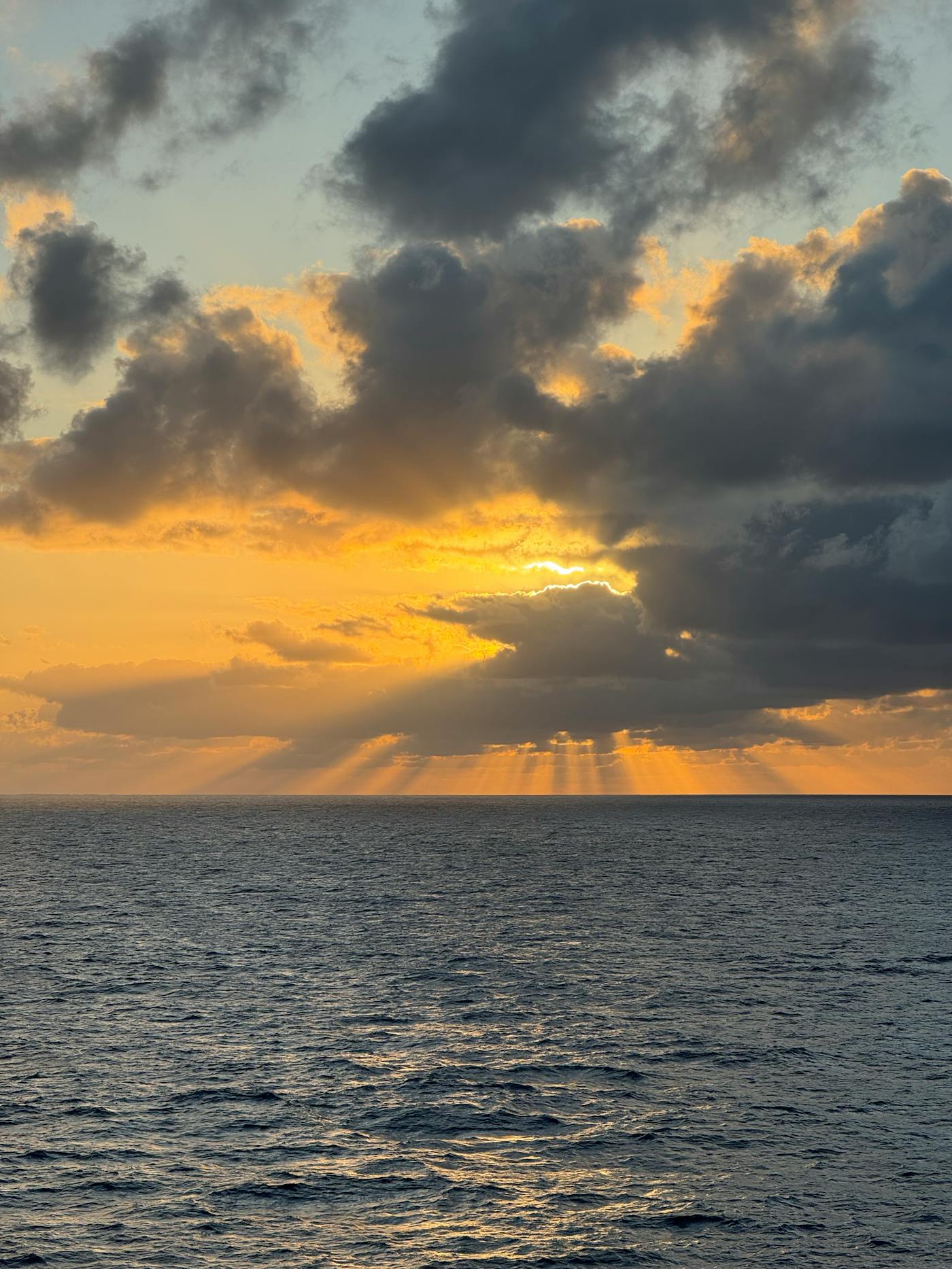Warm sunrise over the ocean with soft clouds