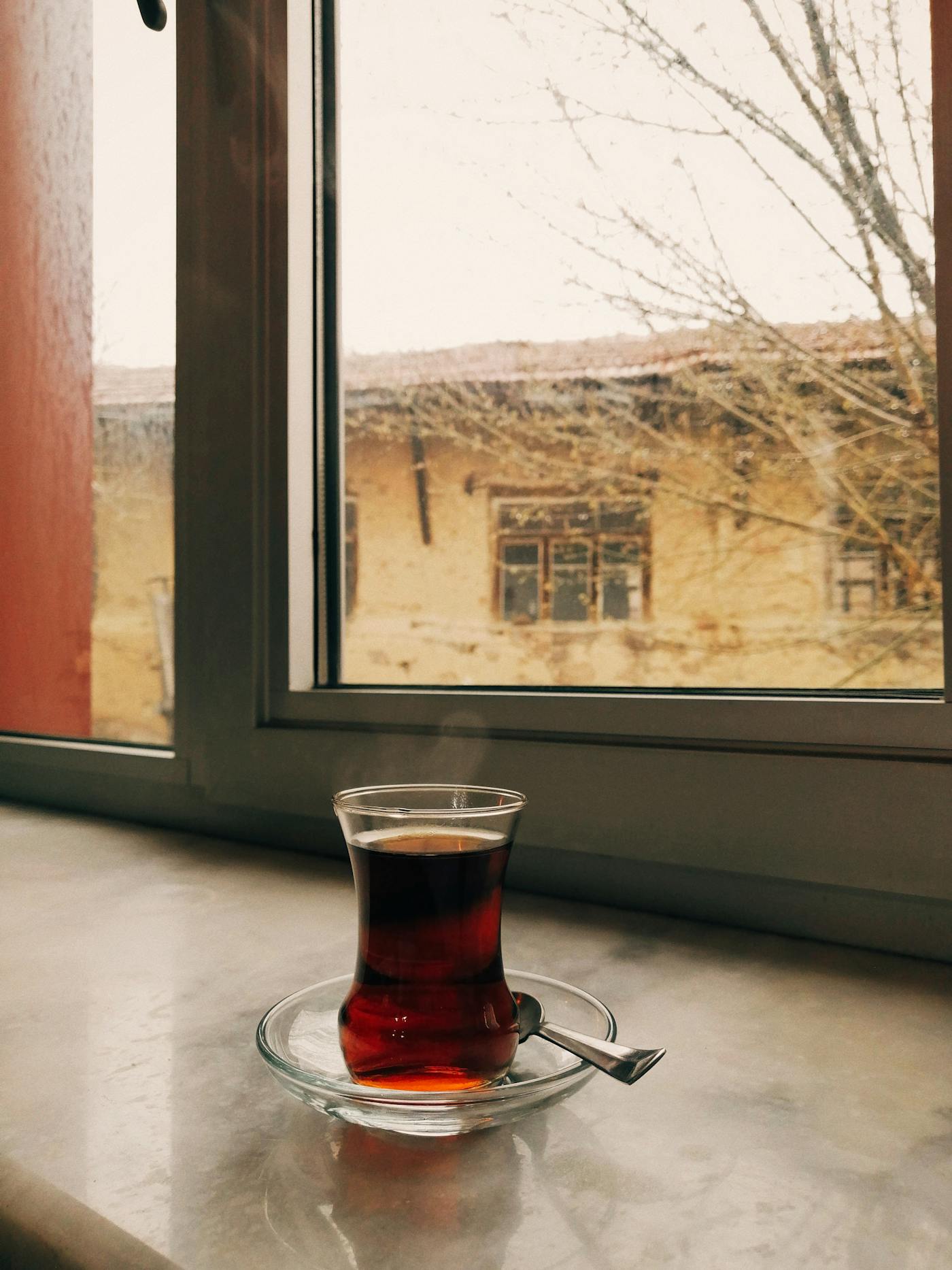 A warm cup of tea resting on a sunlit windowsill